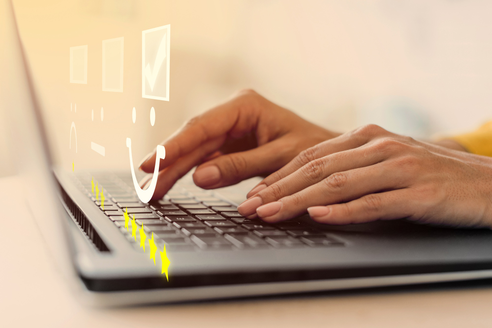 Hands typing on a laptop with a checklist and form icons floating above the keyboard